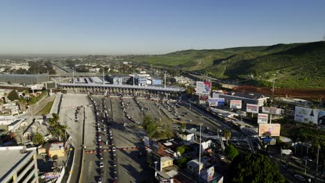 Aerial-view-towards-the-San-Ysidro-Port-of-Entry,-queues-of-cars-crossing-the-border-in-Tijuana,-Mexico