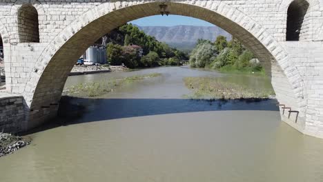 Flight-under-the-bridge-of-Berat,-world-heritage-site,-Albania