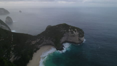 Drone-shot-over-Bali-Kelingking-beach-with-blue-water-and-big-waves