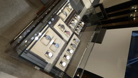 Vertical-high-angle-shot-of-Schaffhausen-watches-on-display-in-luxury-watch-store