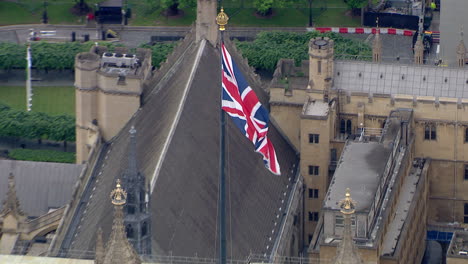 Aerial-zoom-out-shot-of-Palace-of-Westminster-on-the-river-Thames-with-ongoing-construction