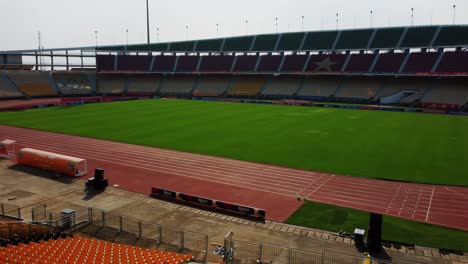 Aerial-view-inside-the-Amadou-Ahidjo-stadium,-in-sunny-Yaounde,-Cameroon---tracking,-drone-shot