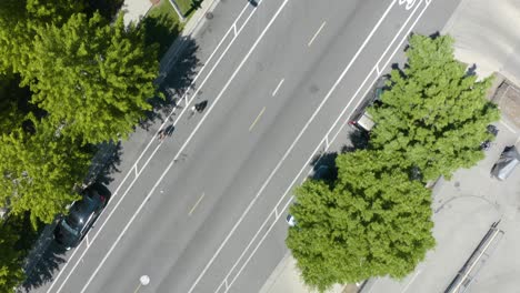 Top-Down-View-of-People-Cycling-on-City-Street-in-Summer