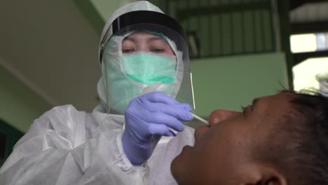 Coronavirus-Test-–-Medizinisches-Personal-Entnimmt-Einem-Potenziell-Infizierten-Mann-In-Isolationskittel-Oder-Schutzanzug-Und-Chirurgischer-Gesichtsmaske-Einen-Abstrich-Für-Eine-Coronavirus-Probe