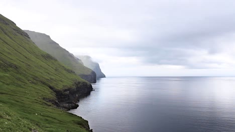 View-of-green-peaceful-mountain-range-in-the-Faroe-Islands-on-a-cold-misty-day