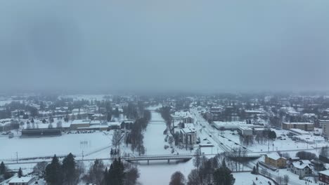Aerial-of-flying-over-a-small-city-during-snow-storm