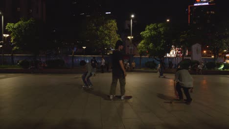 Shot-of-a-skateboarder-performing-a-flip-trick-on-a-skateboard-at-a-skatepark-at-night-in-Ho-Chi-Minh-City,-Vietnam