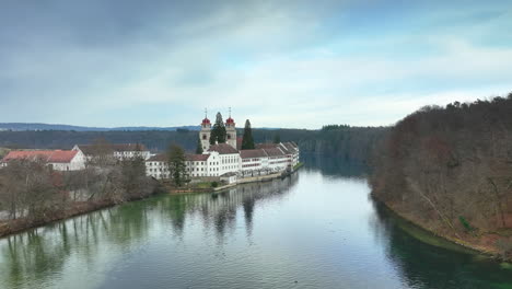 Drone-dolley-shot-of-the-historical-kloster-Rheinau-which-was-a-Benedictine-monastery-in-Rheinau-in-the-Canton-of-Zürich-on-a-cloudy-day