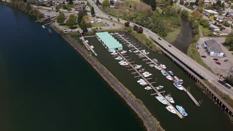 Harbor-Quay-and-Boats-Docked-at-Marina-Docks-at-Port-Alberni,-British-Columbia-Canada,-Aerial-Descending-View