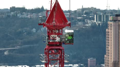 Tower-crane-turning-through-static-aerial-shot-with-long-zoom