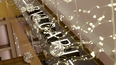 Vertical-video-of-Bulgari-shopping-mall-sign,-exterior-of-store,-handheld