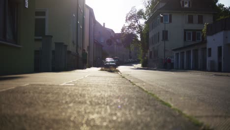 Man-and-Family-Walking-Near-Church-in-Tubingen,-Germany-in-4K-Downtown-Home-of-Europes-Oldest-University-At-Sunset