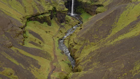 Aerial:-Drone-reveal-shot-of-Kvernufoss-waterfall-in-southern-Iceland-during-an-overcast-day