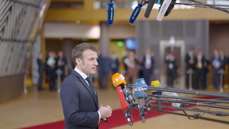 French-president-Emmanuel-Macron-talking-to-the-press-in-the-European-Council-building-during-EU-summit-in-Brussels,-Belgium