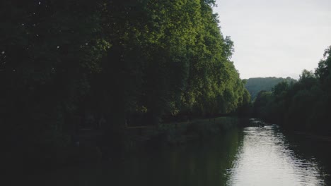 Duck-Crossing-River-Alone-In-Tubingen,-Germany-in-4K-Downtown-Home-of-Europes-Oldest-University-At-Sunset
