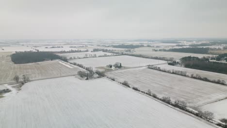 Beautiful-Aerial-View-Above-Rural-Farmland,-Winter-Day-in-Midwest-America