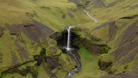 Aerial:-Panormaic-orbit-shot-of-Kvernufoss-waterfall-in-Iceland