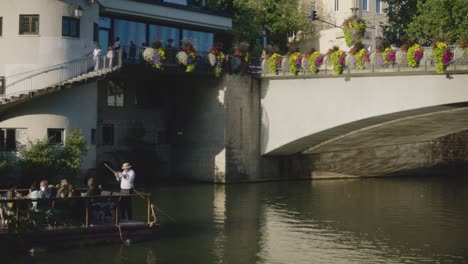 Close-up-of-Tourists-on-Boat-In-Tubingen,-Germany-in-4K-Downtown-Home-of-Europes-Oldest-University-At-Sunset