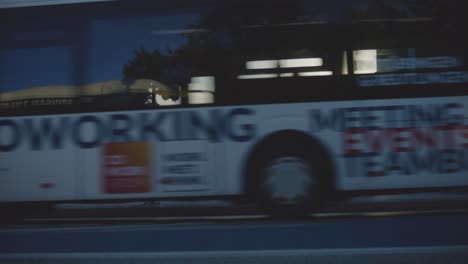 Bike-and-Bus-Passing-by-in-Tubingen,-Germany-in-4K-Downtown-Home-of-Europes-Oldest-University-At-Sunset