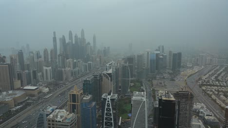 4K:-Foggy-morning-at-Dubai-Marina-District,-Dubai-skyscrapers-with-city-traffic