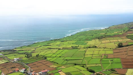 Aerial-View-of-Patchwork-Fields-And-Blue-Sea-In-Azores,-Terceira-Island
