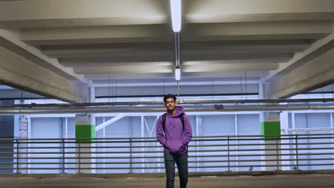 Young-Sri-Lankan-man-approaching-in-slow-motion-towards-the-camera-in-a-subway-parking-garage