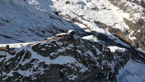 Aerial-view-of-a-rocky-facade-in-a-Swiss-alps-mountain-in-winter