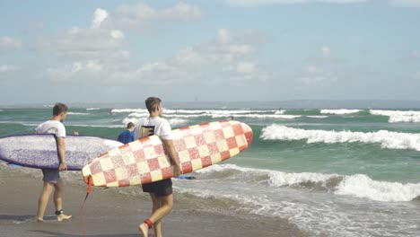Surfers-walking-up-to-the-waves-at-Batu-Bolong-beach-in-Bali-Canggu