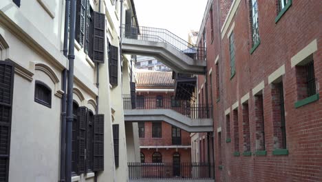 Looking-Along-Narrow-Courtyard-With-People-Walking-Past-At-Tai-Kwun-In-Hong-Kong