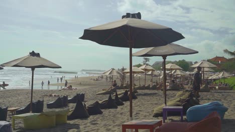 Parasols-and-beanbag-chairs-lined-up-on-the-beach-in-Bali-Canggu