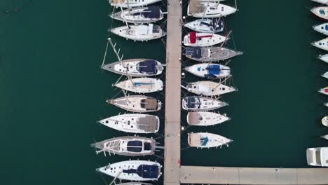 Drone-top-down-shot-of-yachts-docked-up-at-the-marina