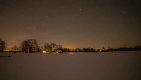 Timelapse-of-a-snowy-landscape-with-a-wooden-house-in-a-frozen-field-and-the-milky-way-advancing-in-a-starry-sky