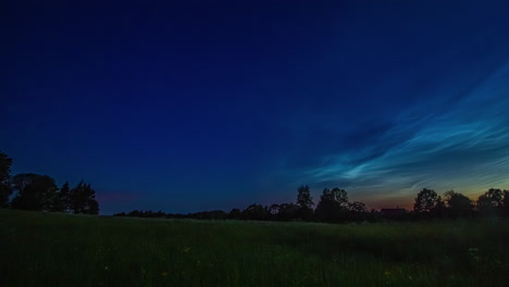 Clouds-rolling-above-rural-landscape,-fusion-time-lapse-night-to-day
