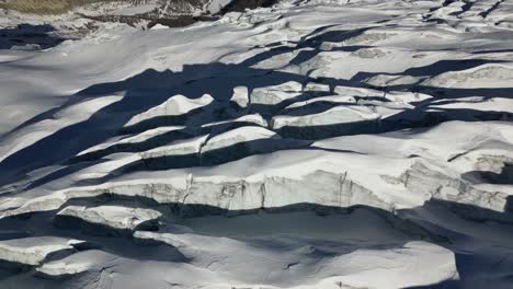 aerial:-crevasses-made-of-ice-in-the-swiss-alps,-ski-danger