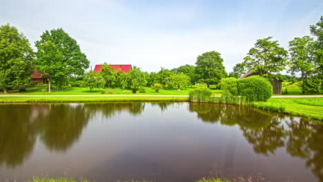 Time-lapse-of-lake-near-a-european-houses,-a-public-pond-for-fishing