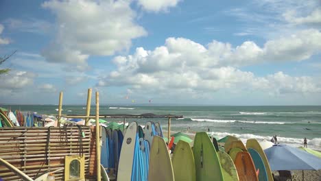 Endless-surfboards-lined-up-along-Batu-Bolong-beach,-where-surfing-is-a-popular-activity-for-digital-nomads-who-live-and-work-in-Bali