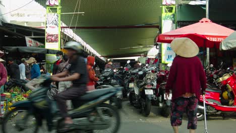 Famous-tourist-market-Cho-Con-with-parked-vehicles-and-tourists-walking-around-and-shopping,-Da-Nang-city,-Vietnam