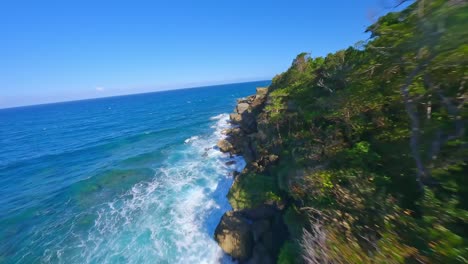 Aerial-freestyle-fpv-drone-flying-along-shore-of-Cabo-Frances-in-Dominican-Republic