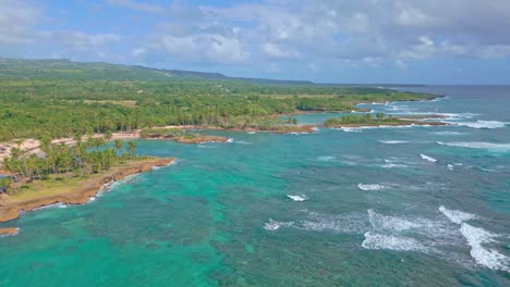 Aerial-view-of-tropical-coastline-with-Playa-Los-Coquitos-during-sunny-day-in-Dominican-Republic