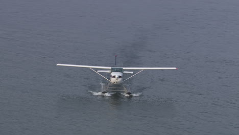Aerial-rotating-shot-of-a-landed-hydroplane-heading-to-the-shore-of-Lake-Como,-Italy