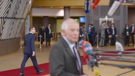 Swedish-Prime-Minister-Ulf-Kristersson-walking-on-the-red-carpet-in-the-European-Council-building-during-EU-summit-in-Brussels,-Belgium