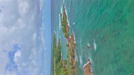 Aerial-backward-over-Los-Coquitos-rocky-coast,-Cabrera-in-Dominican-Republic