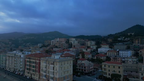 Italian-village-with-buildings-by-a-lake-on-a-cloudy-and-dark-day-in-Varazze,-Savona,-Liguria-region
