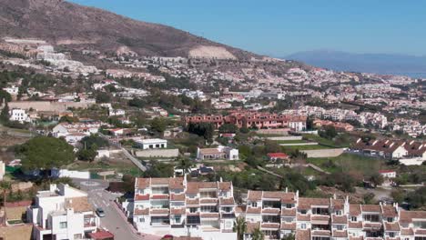 Dolly-right-aerial-showing-vast-landscape-of-city-Benalmadena-in-Spain