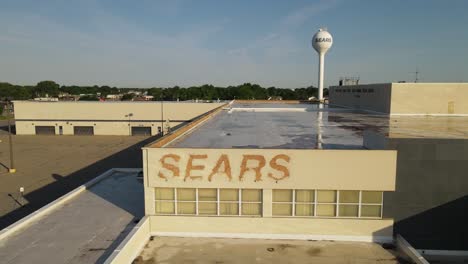 SEARS-logo-on-empty-derelict-building-after-bankrupt,-aerial-drone-view