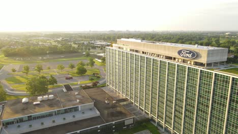 Sunshine-glows-over-Ford-Motors-Company-building,-aerial-drone-view