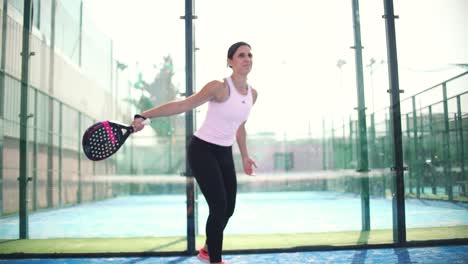 Murcia-Spain---February-21-2023:-Young-sportswoman-and-man-couple-playing-padel-tennis-in-slow-motion