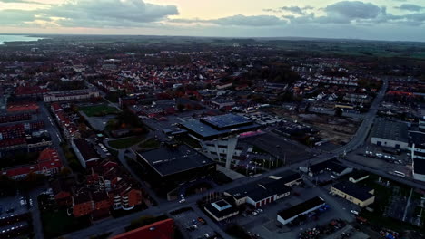 Aerial-flight-over-Ystad-Arena-during-dusk-in-Ystad-City,-Sweden---Descending-shot