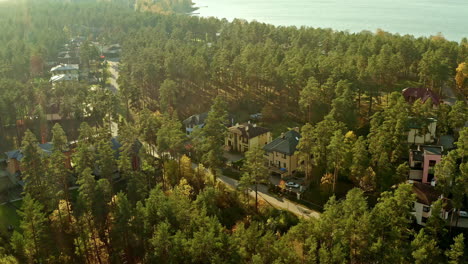 Sunset-drone-flight-over-a-modern-home-development-in-the-forested-countryside