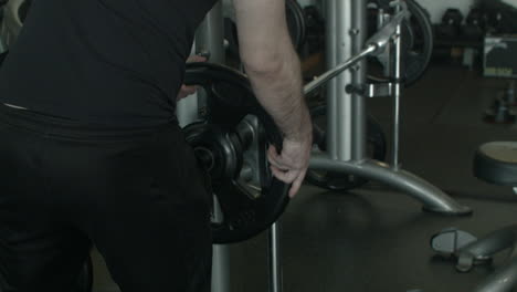 Extreme-Close-Up-of-a-Man-Adding-Weights-to-a-Machine-at-the-Gym